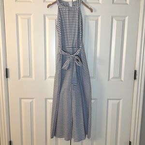 Adorable striped jump suit with flared legs and tie at the waist.